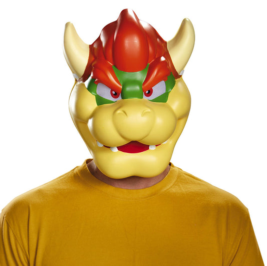 Adult wearing a Super Mario Brothers Bowser mask with a fierce expression, predominantly yellow with red and green accents on the face.