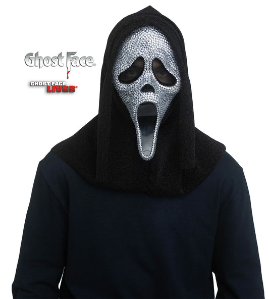 Person wearing a black hooded costume with a jewelled mask featuring a ghost face design on a white background.