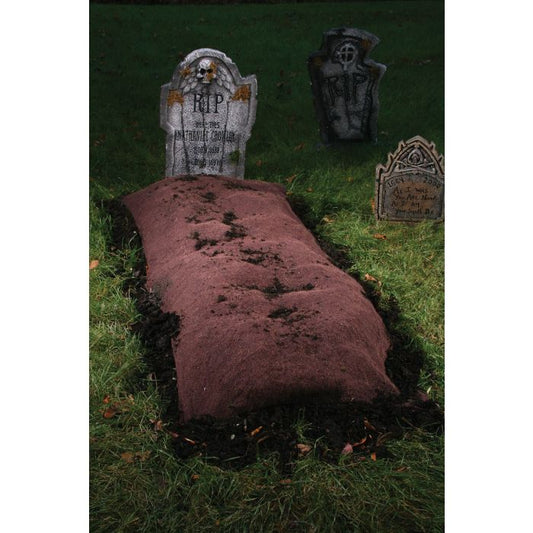 A grave mound with stakes designed for Halloween party decoration, placed over a burlap blanket on the grass.